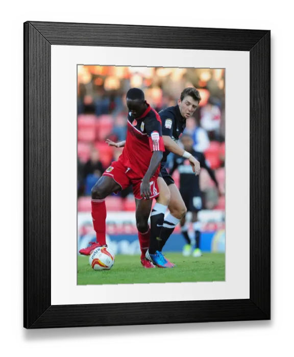 Framed Print : Adomah vs Stephens: Intense Battle for Possession in Bristol City vs Charlton Athletic Championship Clash