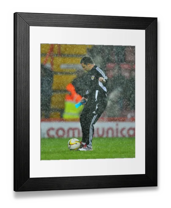 Framed Print : Derek McInnes Investigates Floodlit Pitch as Championship Match between Bristol City and Watford is Abandoned (December 26, 2012)