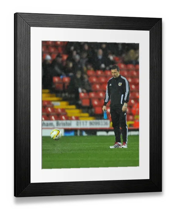 Framed Print : Bristol City vs. Watford: Derek McInnes Examines the Pitch Before Referees Call Off Championship Match (December 2012)