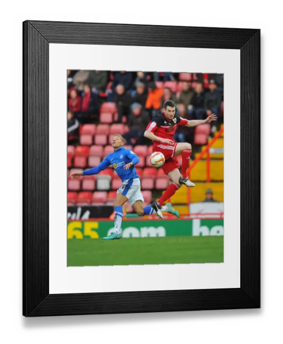 Framed Print : McManus vs Gayle: Aerial Battle in Championship Football - Bristol City vs Peterborough United