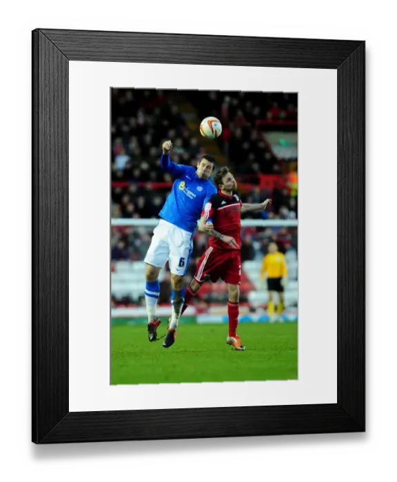 Framed Print : Intense Header Battle: Paul Anderson vs Michael Bostwick - Bristol City vs Peterborough United