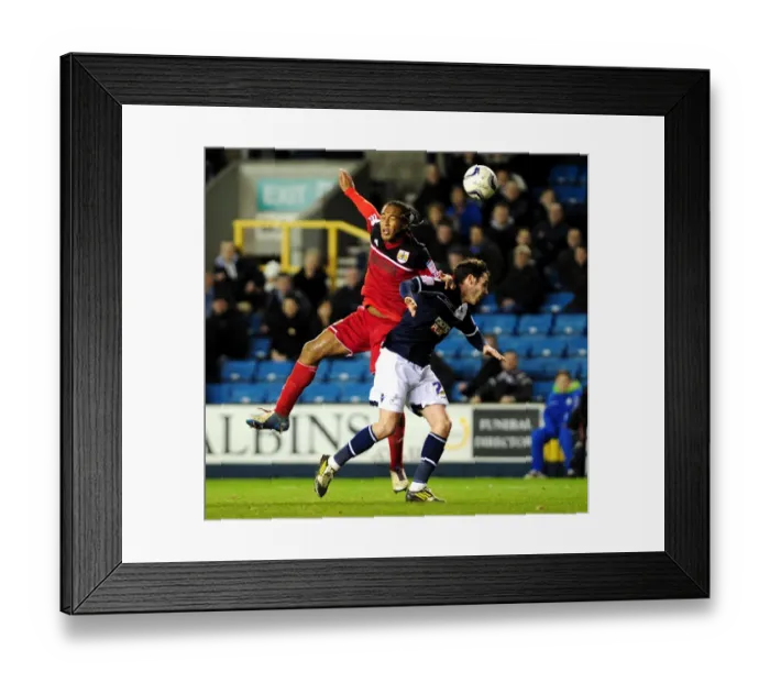 Framed Print : Neil Danns vs. Alan Dunne: Aerial Battle in Millwall vs. Bristol City Championship Clash Framed Print : Neil Danns vs. Alan Dunne: Aerial Battle in Millwall vs. Bristol City Championship Clash