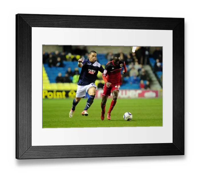 Framed Print : Adomah vs. Feeney: Intense Rivalry on The Den's Football Field - Championship: Millwall vs. Bristol City (January 2013)