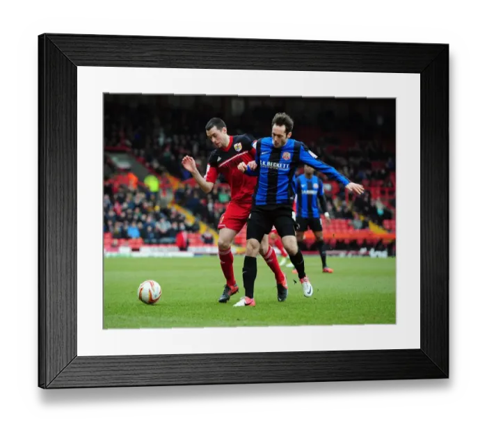 Framed Print : Bristol City vs Barnsley: Intense Battle for the Ball between Brendan Moloney and James O'Brien Framed Print : Bristol City vs Barnsley: Intense Battle for the Ball between Brendan Moloney and James O'Brien