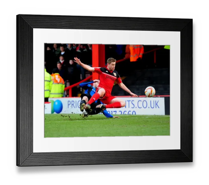 Framed Print : Bristol City vs Barnsley: Intense Moment as Martin Cranie Tackles Steven Davies in Npower Championship Match