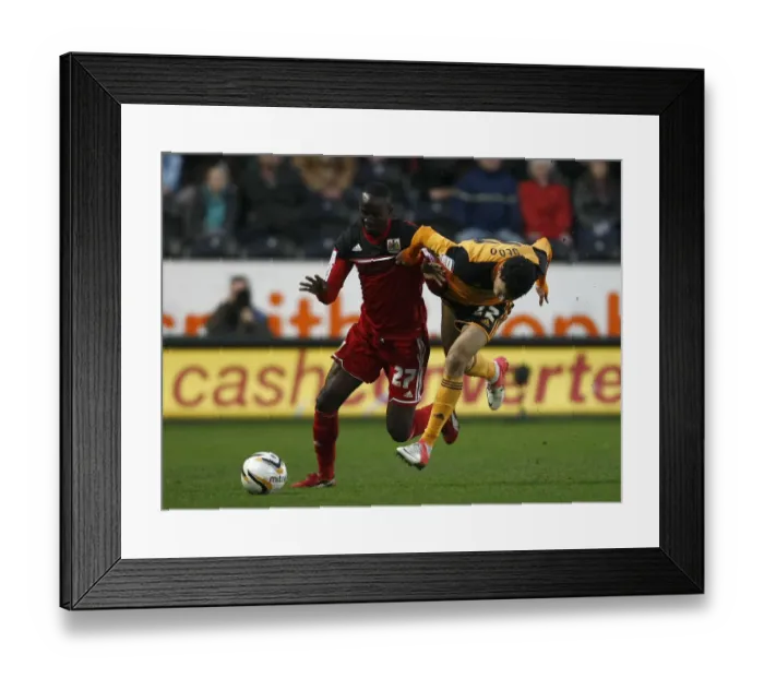 Framed Print : Adomah vs Gedo: Intense Battle on the Football Field - Hull City vs Bristol City, 2013