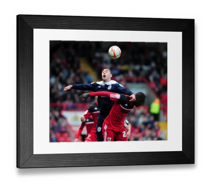 Framed Print : Intense Aerial Battle: Albert Adomah vs Lee Novak - Bristol City vs Huddersfield Town Football Match Framed Print : Intense Aerial Battle: Albert Adomah vs Lee Novak - Bristol City vs Huddersfield Town Football Match