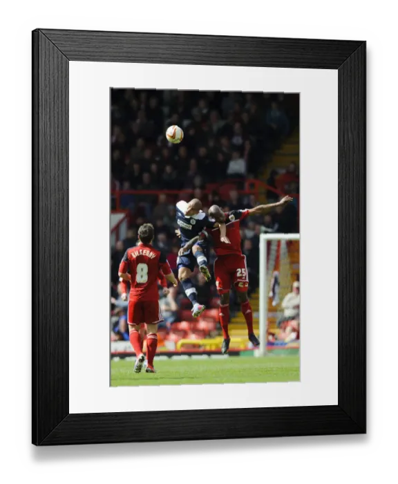Framed Print : Bristol City vs. Huddersfield: Marvin Elliott and James Vaughan Battle in the Air during the Championship Clash at Ashton Gate