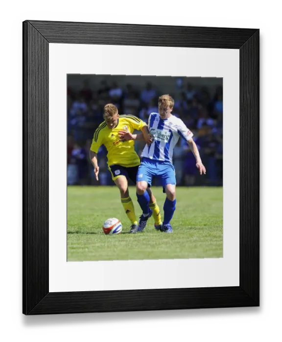 Framed Print : Bristol City vs Clevedon Town: Intense Battle Between Rhys Jordan and Adi Adams