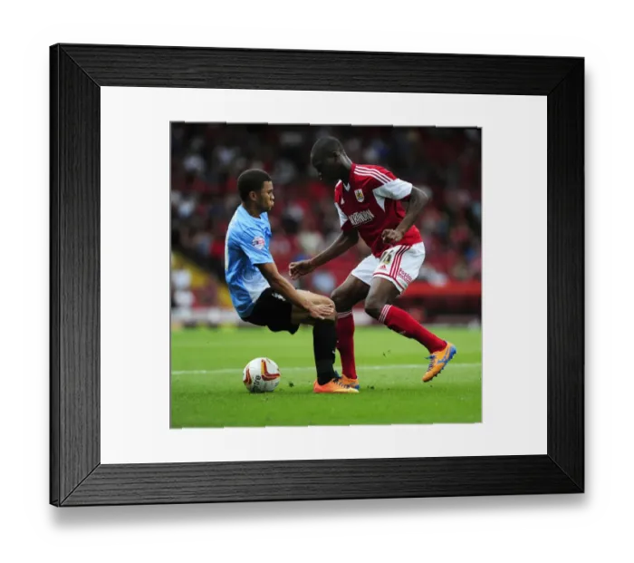 Framed Print : Escaping the Pressure: Jordan Wynter Evades Nahki Wells in Sky Bet League One Clash
