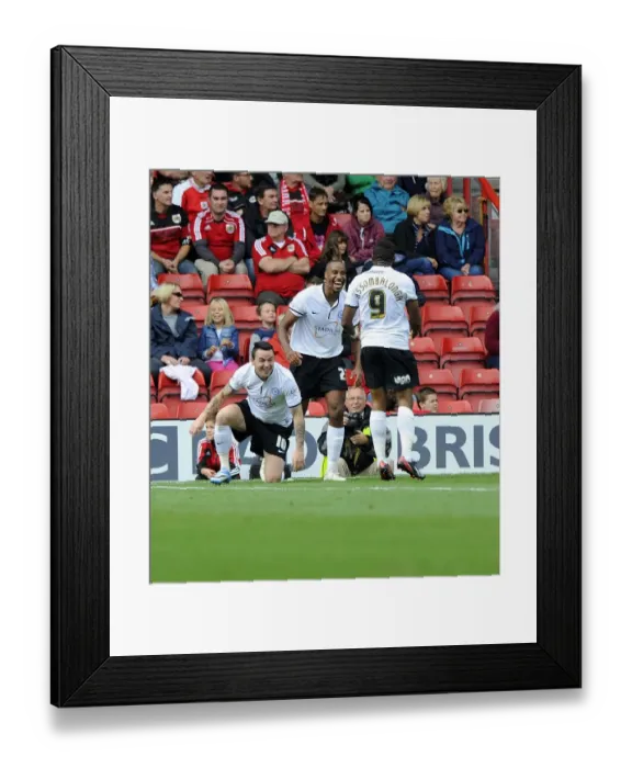 Framed Print : Celebrating the Goal: Barnett, Assombalonga, and Tomlin of Peterborough United at Ashton Gate after Scoring against Bristol City (September 14, 2013)