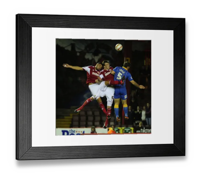 Framed Print : Bristol City Rivals Aden Flint and Derrick Williams Clash in Aerial Battle Against Shrewsbury Town Framed Print : Bristol City Rivals Aden Flint and Derrick Williams Clash in Aerial Battle Against Shrewsbury Town