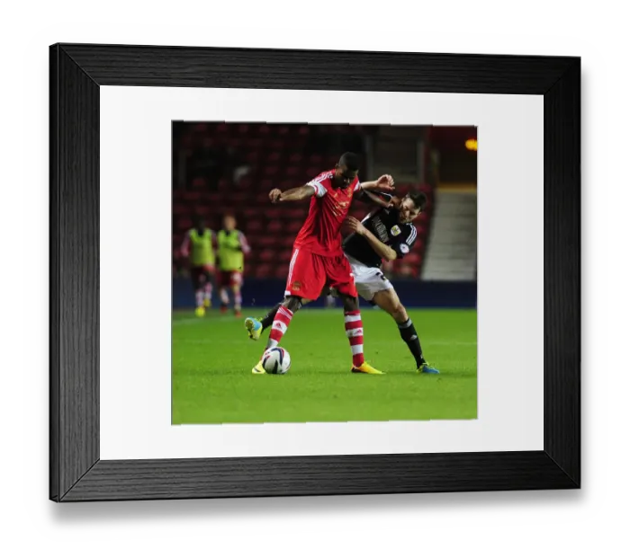 Framed Print : Brendan Moloney vs Guilherme do Prado: Intense Clash in Southampton vs Bristol City Football Match, 2013