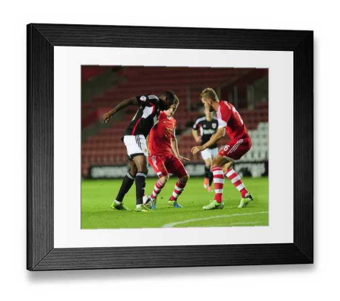 Framed Print : Jay Emmanuel-Thomas Tries to Beat Southampton's Defense - Football Rivalry at St Mary's Stadium, 2013