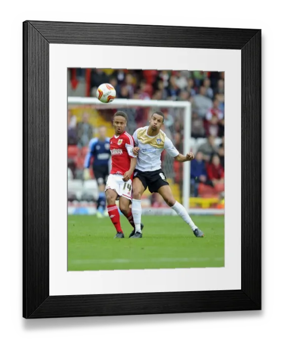 Framed Print : Bobby Reid vs Craig Eastmond: Intense Battle for Possession in Bristol City vs Colchester United