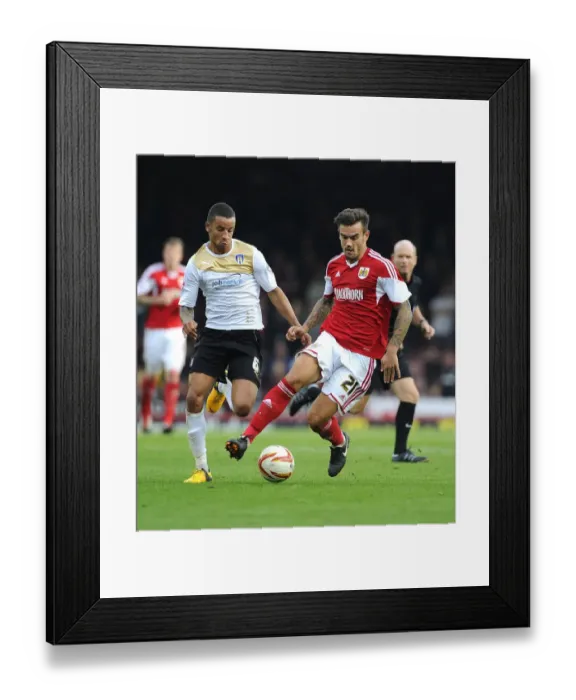 Framed Print : Maron Pack vs Craig Eastmond: Intense Battle for Possession in Bristol City vs Colchester United Football Match, September 2013