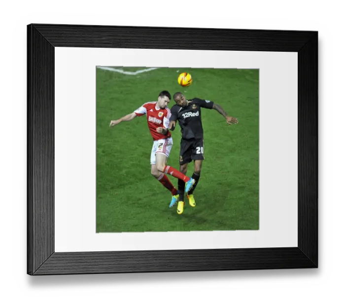 Framed Print : Brendan Moloney vs Emile Sinclair: Intense Battle for a High Ball in Cardiff City vs Swansea City Football Match