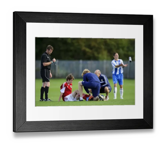 Framed Print : Bristol City U18's Tom Fry Receives Medical Attention During Match Against Brighton & Hove Albion U18