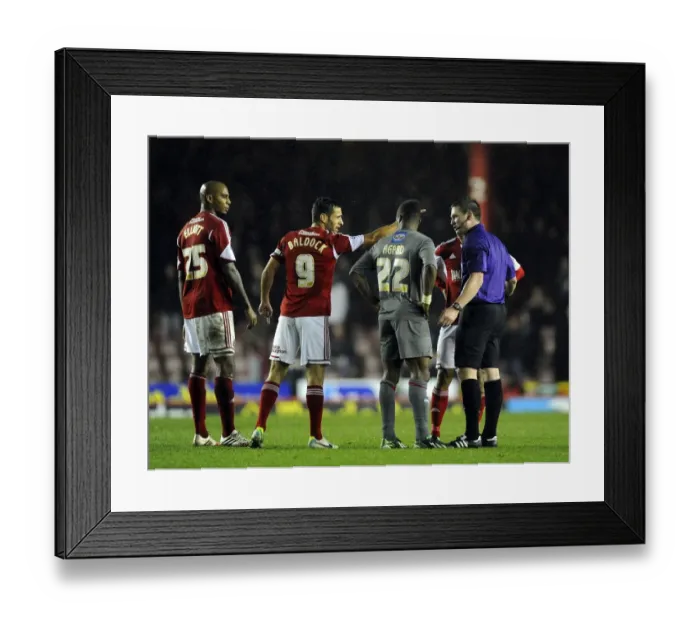 Framed Print : Controversial Moment: Kieran Agard Evades Bobby Reid's Challenge in Bristol City vs Rotherham United