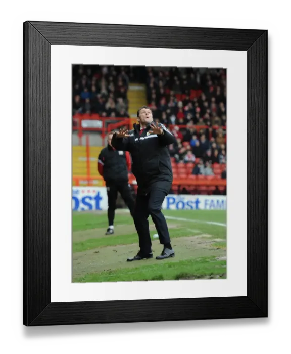 Framed Print : Steve Cotterill's Playful Moment: A Distracted Focus at Ashton Gate during Bristol City vs MK Dons (18 / 01 / 2014)