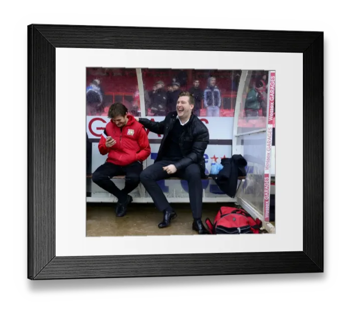 Framed Print : Milton Keynes Dons Manager Karl Robinson Shares a Light-Hearted Moment with His Bench Before the Bristol City Match
