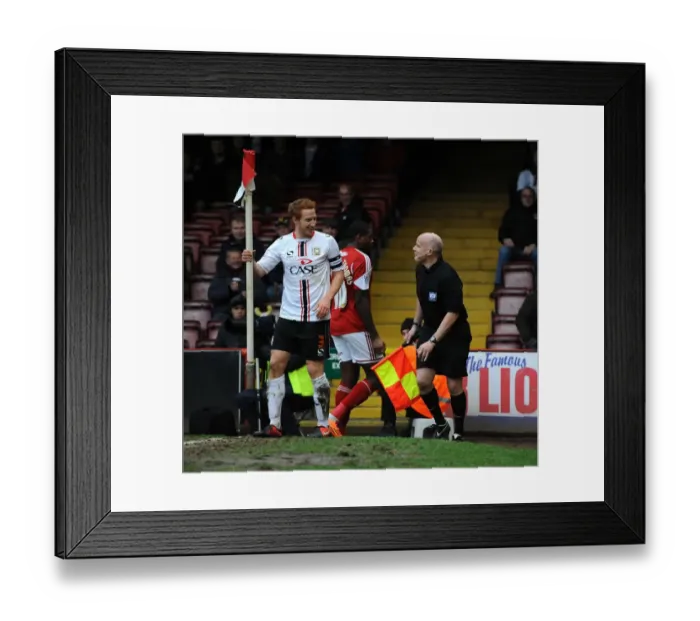 Framed Print : Dramatic Moment: Dean Lewington Slides Out MK Dons Teammate into Linesman during Bristol City vs MK Dons Match