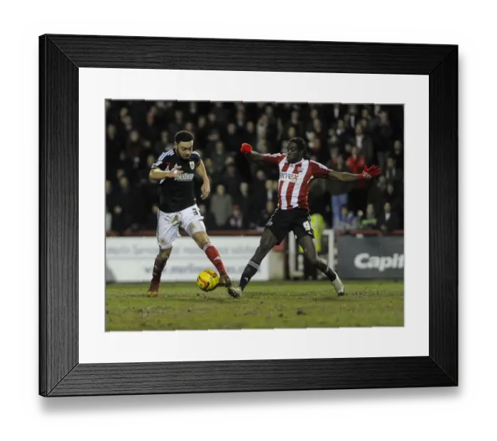 Framed Print : Bristol City's Derrick Williams and Brentford's Clayton Donaldson Battle for the Ball in Sky Bet League One Clash at Griffin Park, January 2014