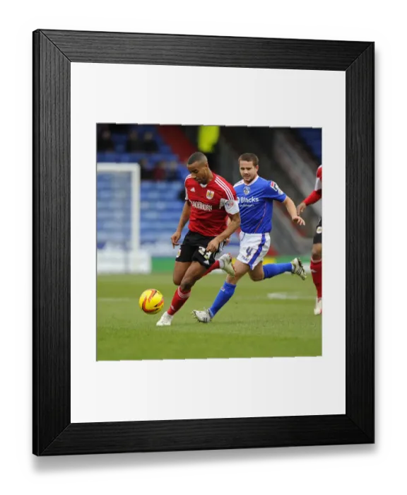 Framed Print : Bristol City's Tyrone Barnett Fights for Possession Against Oldham Athletic's James Wesolowski in Sky Bet League One Clash
