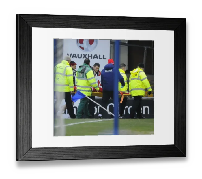 Framed Print : Steve Cotterill Comforts Injured Marvin Elliott: Oldham Athletic vs. Bristol City, 08-02-2014