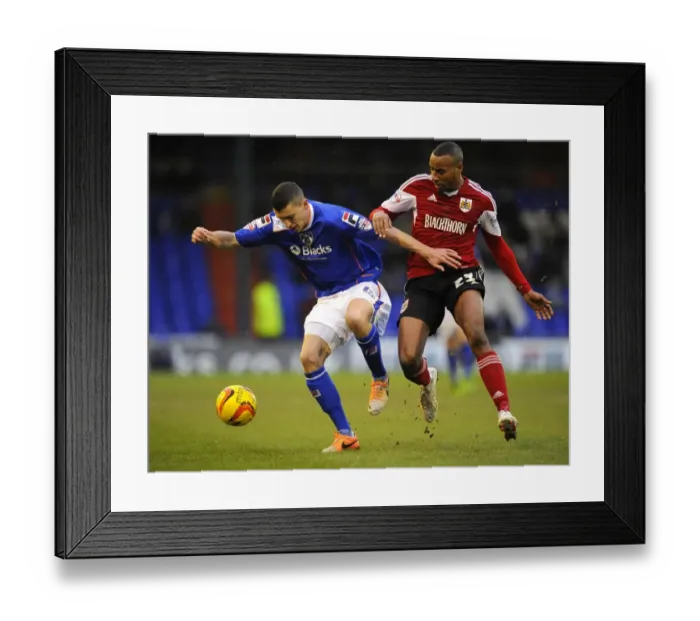Framed Print : Battling for Possession: Tyrone Barnett vs. James Wilson in Sky Bet League One (Oldham v Bristol City) Framed Print : Battling for Possession: Tyrone Barnett vs. James Wilson in Sky Bet League One (Oldham v Bristol City)