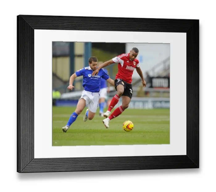 Framed Print : Bristol City's Tyrone Barnett vs Oldham Athletic's James Wesolowski: A Fight for Supremacy in Sky Bet League One