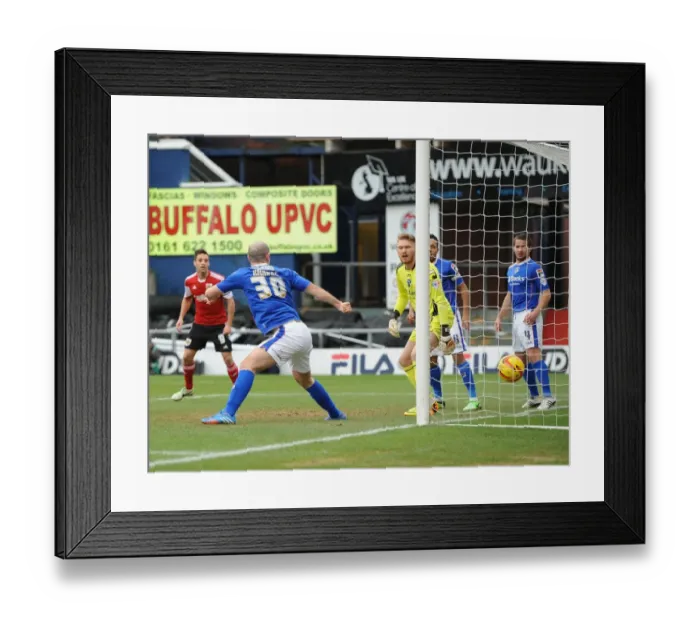 Framed Print : Aden Flint Scores Past Helpless Gary Harkins in Oldham Athletic vs. Bristol City Match