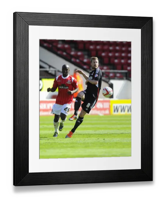 Framed Print : Battling for Supremacy: Wade Elliott vs. Febian Brandy in Walsall vs. Bristol City Football Match