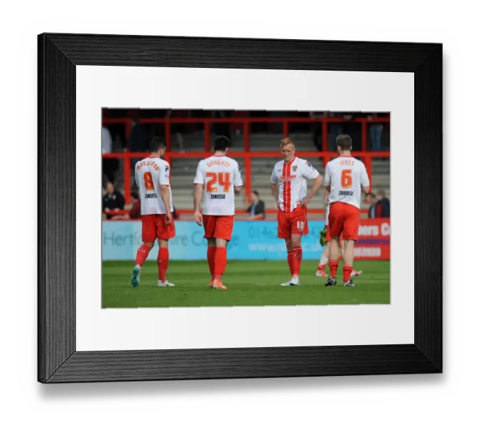 Framed Print : Stevenage players cut dejected figures after the game as they lose 1 - 3 to Bristol City resulting in them being