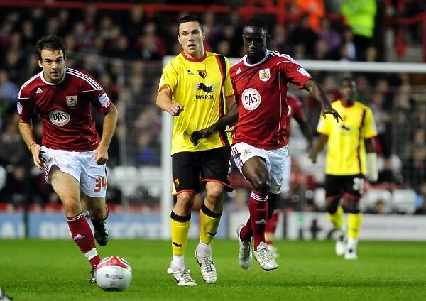 Adomah vs. Cowie: Intense Battle for the Ball in Bristol City vs. Watford Championship Match