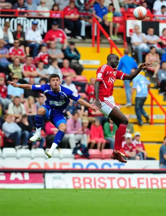 Framed Print : Adomah vs. Cresswell: Intense Battle for High Ball in Bristol City vs. Ipswich Town Championship Match