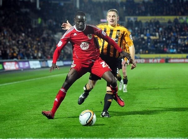 Adomah vs Dawson: Intense Battle for Ball Possession in Hull City vs Bristol City Championship Clash (18 / 12 / 2010)