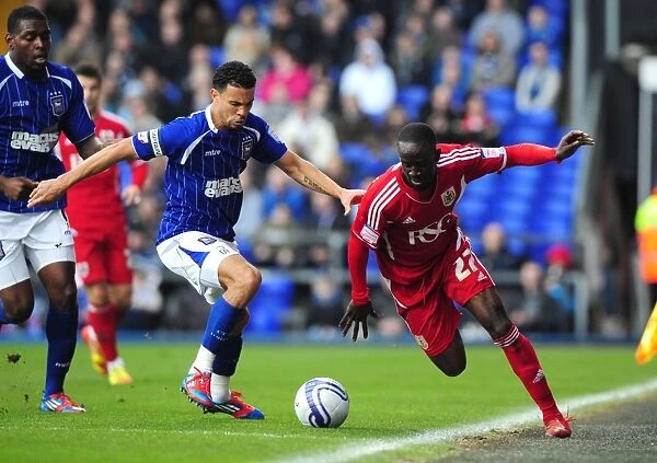 Adomah vs Edwards: Intense Battle for Ball Possession during Ipswich Town vs Bristol City Football Match, Portman Road, 2012