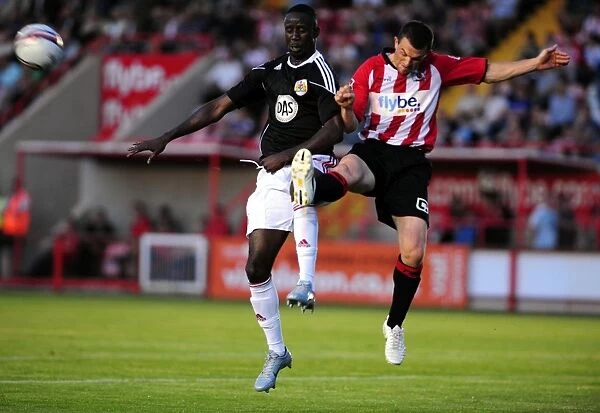 Adomah's Determined Struggle: Battling for the Ball in the Exeter City vs. Bristol City Match