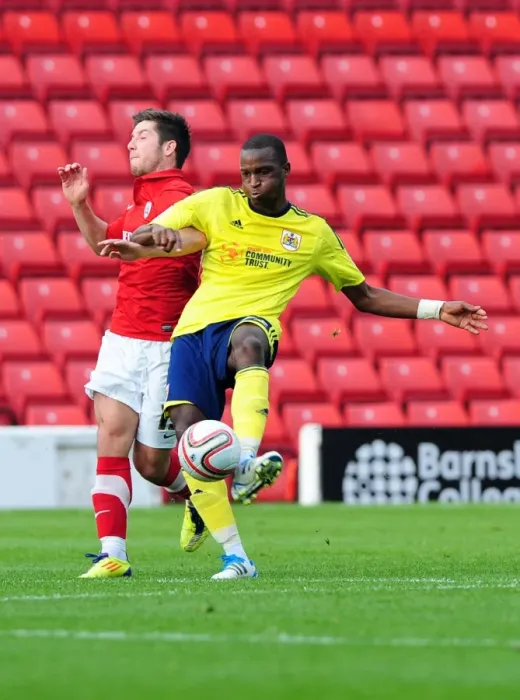Framed Print : Barnsley vs. Bristol City: Cisse vs. McNulty - Championship Battle for Possession (October 2011)