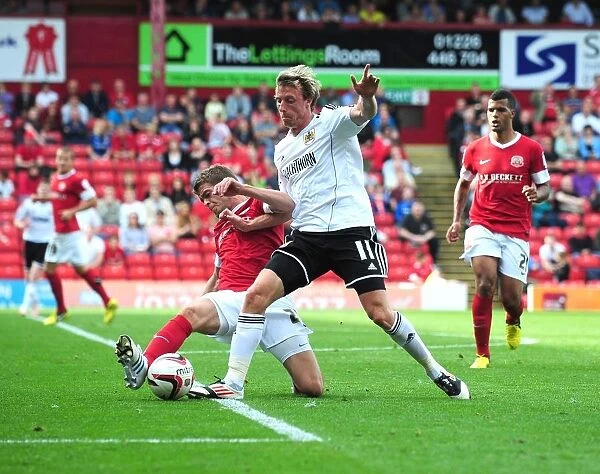 Barnsley's Noble-Lazarus Tackles Woolford in Championship Clash between Barnsley and Bristol City