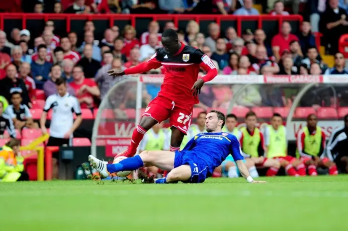 Framed Print : A Battle for Possession: Mutch vs. Adomah in the Championship Clash at Ashton Gate