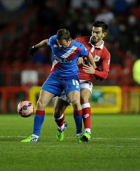 Battling for the Ball: Marlon Pack vs. Richard Wellens in FA Cup Third Round Replay at Ashton Gate Stadium