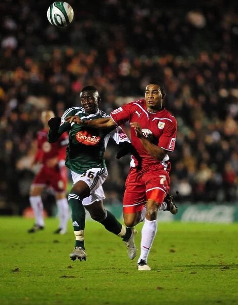 Battling for Control: Marvin Elliott vs. Yannick Bolasie in the Intense Championship Showdown between Plymouth Argyle and Bristol City (16 / 03 / 2010)