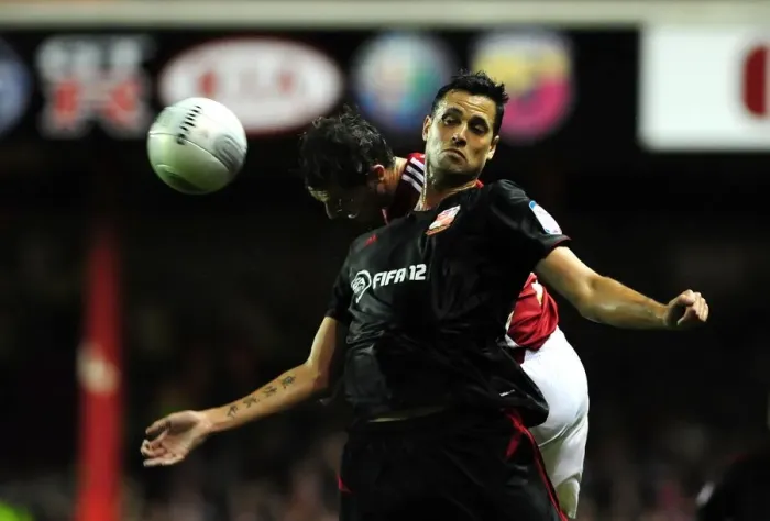 Framed Print : Battling for the High Ball: McAllister vs. Magera in the 2011 League Cup Clash (Bristol City vs. Swindon Town) Framed Print : Battling for the High Ball: McAllister vs. Magera in the 2011 League Cup Clash (Bristol City vs. Swindon Town)
