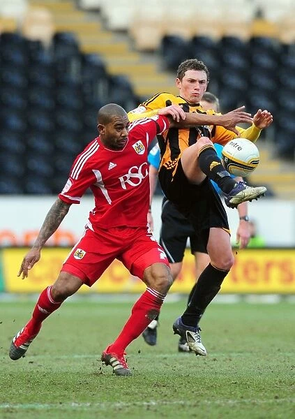 Battling Midfielders: Marvin Elliott of Bristol City and Corry Evans of Hull City Clash in Championship Match, 11 / 02 / 2012