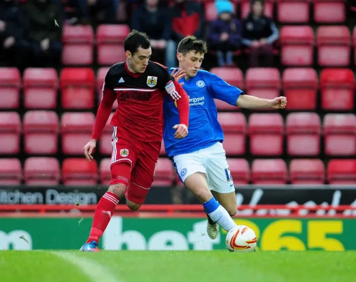 Framed Print : Battling for Possession: Gregg Cunningham vs. Joe Newell in Championship Clash between Bristol City and Peterborough United Framed Print : Battling for Possession: Gregg Cunningham vs. Joe Newell in Championship Clash between Bristol City and Peterborough United