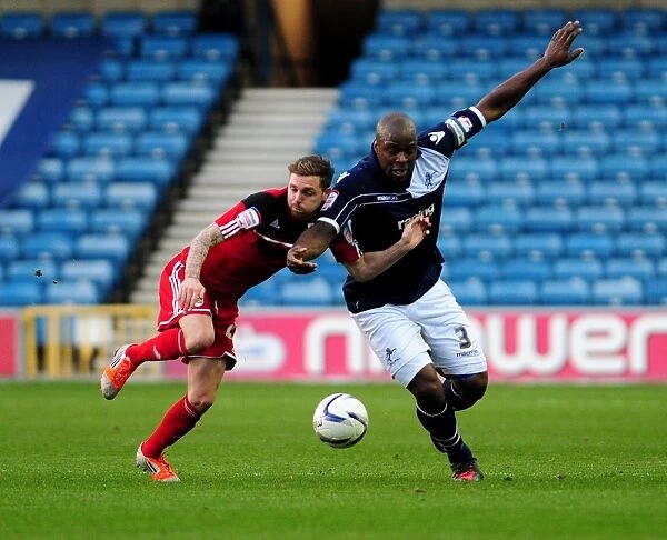 Battling for Possession: Paul Anderson vs. Danny Shittu in the Championship Clash between Millwall and Bristol City