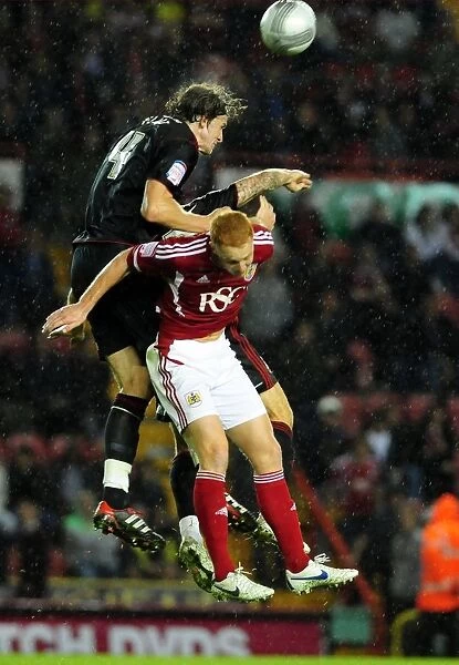 Battling for Supremacy: Aden Flint vs. Ryan Taylor in the 2011 League Cup Clash between Bristol City and Swindon Town