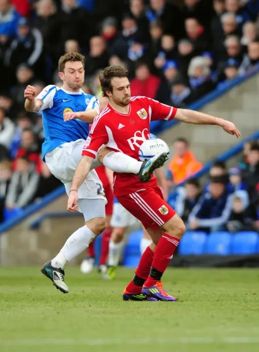 Framed Print : Battling for Supremacy: Brett Pitman vs. Lee Frecklington in Peterborough United vs. Bristol City Football Match